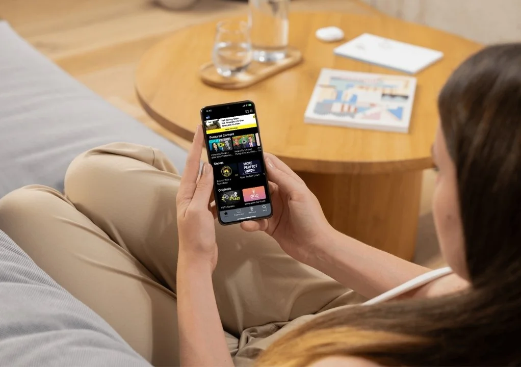 Person watching Free Speech TV on a mobile phone